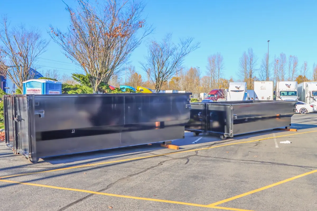 Professional dumpster rental service with roll-off container on residential driveway in Kilgore